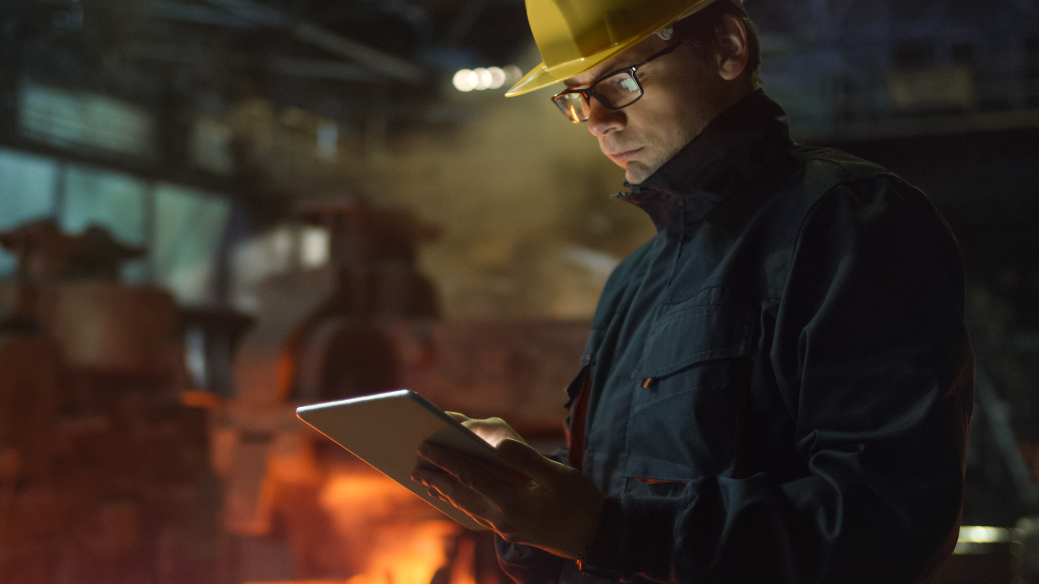 Engineer in Glasses using Tablet PC in Foundry in Industrial Environment to represent technology adoption in manufacturer rep industry